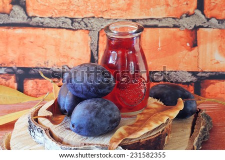 plum fruit compote juice on a wooden table fresh brick wall eco farm products