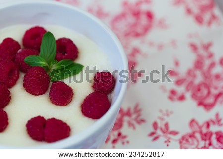 Breakfast semolina porridge with fresh raspberries mint leaves home food health selective soft focus