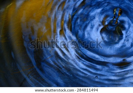 water drop with blue and orange reflect background
