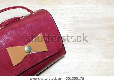 soft focus, red small bag on wood background
