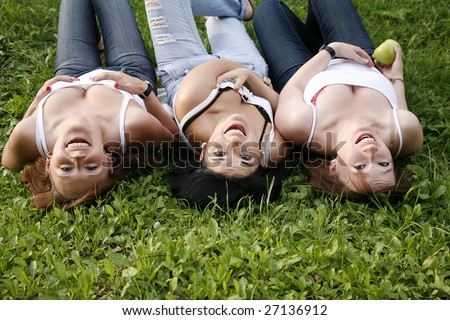 happy friends laughing on the grass