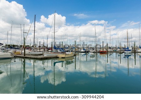 Auckland, New Zealand - November 16: Many private boats and yachts dock in Harbor in Auckland with nice reflection on water surface on November 16, 2013 in Auckland, New Zealand