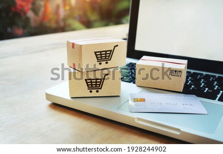 Shopping online concept,Paper boxes on a laptop and credit card Consumers can shop from home service.