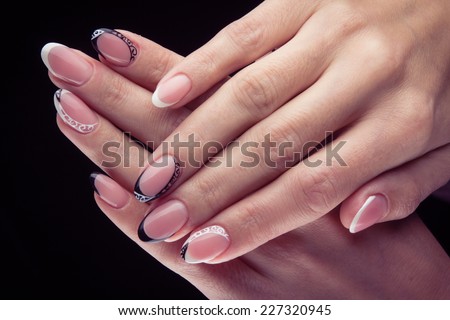 Pretty woman hand with perfect painted gel nails isolated on black background