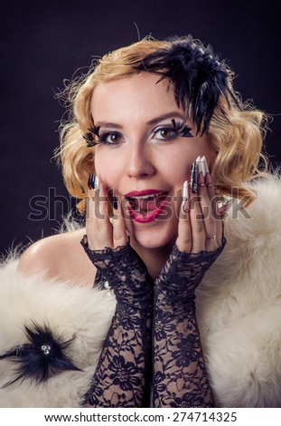 Retro portrait of beautiful wondering happy blonde wondering smiling woman with jewels and extreme long nails. Gatsby, Vintage style. Isolated on black background