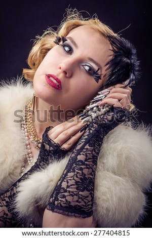 Retro portrait of beautiful blonde woman with jewels and extreme long nails. Gatsby, Vintage style. Isolated on black background
