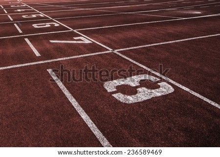 A close-up of the starting point at a running track.