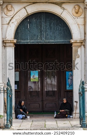 LAGOS, PORTUGAL  November 21, 2014: Two elderly women moaning her loss in front of a church in Lagos
