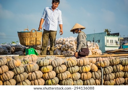 MEKONG, VIETNAM February 21, 2014: two people on boat on a floating market in the mekong delta