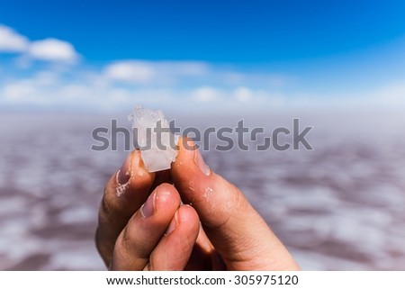 holding a part of the uyuni salt lake in his hands