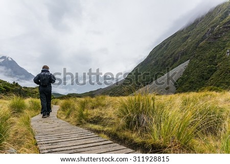 MT COOK NP, NEW ZEALAND Circa APRIL 2014: A guy walking along a trail in mt cook national park