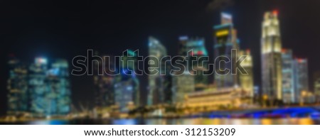 singapores skyline at night seen from the marina bay promenade - picture blurred on purpose using a gaussian blur filter in photoshop