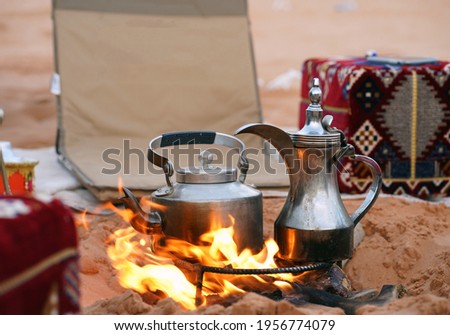Traditional arabic coffee pot and tea pot at the fireplace in the desert, Riyadh, Saudi Arabia