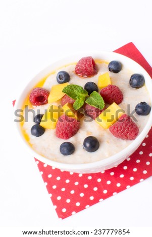 Oat porridge with berries isolated on a white background