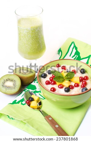 porridge from porridge with berries and juice isolated on a white background