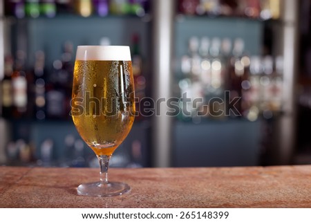 Glass of beer on the marble bar stand