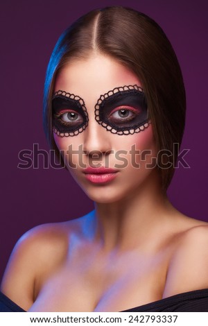 Closeup portrait of beautiful woman with painted art makeup. Natural beauty, clean fresh skin. Looking at camera. Inside