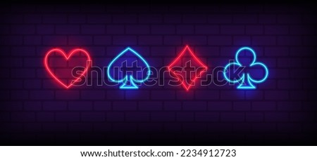 Neon signs set of Suits of playing cards. Card suits, Poker, Blackjack neon icons. Glowing casino signboard. Aces Playing Cards symbols with Glowing Neon Lights on brick wall background