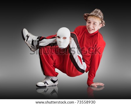 The young boy dances hip-hop