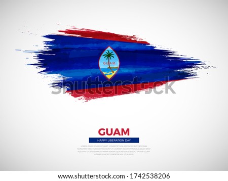 Grunge style brush painted Guam country flag illustration with liberation day typography. Artistic watercolor brush flag vector