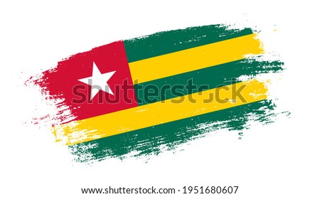 Flag of Togo country on brush paint stroke trail view. Elegant texture of national country flag