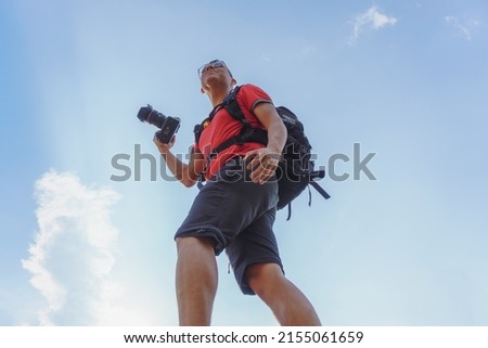 Similar – Image, Stock Photo Male tourist taking photo of nature on camera
