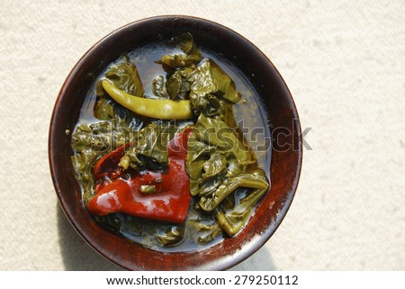 Kashmir green dish which is made by spinach cooked with mustard oil and Indian spices and served with rice