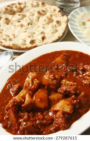 North Indian Curry made with potatoes & cauliflower served with flat bread