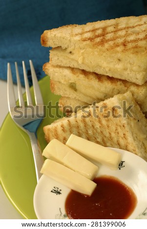 Grilled cheese toast served with tomato sauce