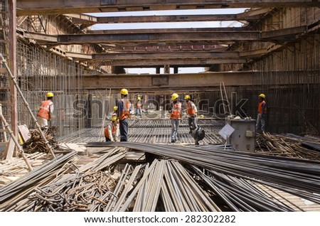 Bangalore, Karnataka, India - January 21, 2014: Unidentified workers are employed in construction overhead metro in bangalore City