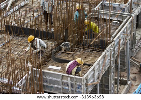 Bangalore, Karnataka, India - September 15, 2010: Unidentified workers are employed in construction overhead metro in bangalore City