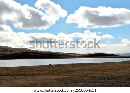 Similar – Image, Stock Photo Autumn field under cumulus clouds in sunlight