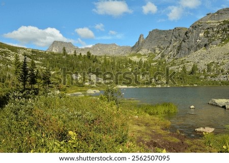 Similar – Image, Stock Photo Rocky mountains surrounding rippling sea under cloudy sky