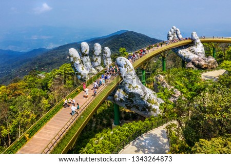 Aerial view of the Golden Bridge is lifted by two giant hands in the tourist resort on Ba Na Hill in Da Nang, Vietnam. Ba Na mountain resort is a favorite destination for tourists Stok fotoğraf © 