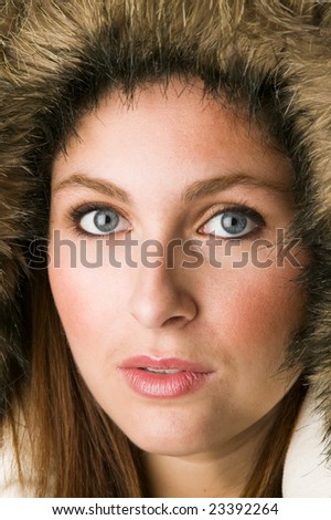 Close up portrait of a pretty woman wearing fur parka