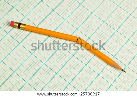 Broken pencil on accounting ledger paper