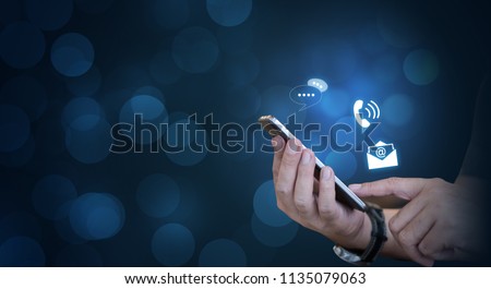 CONTACT US, Hand of a businessman holding a mobile smartphone with the icon. Contact us connection concept with copy space. ストックフォト © 