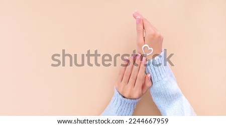 Image, Stock Photo female hands in winter gloves in a red and white striped hugging behind green Christmas tree outdoors. Christmas and New Year holiday concept