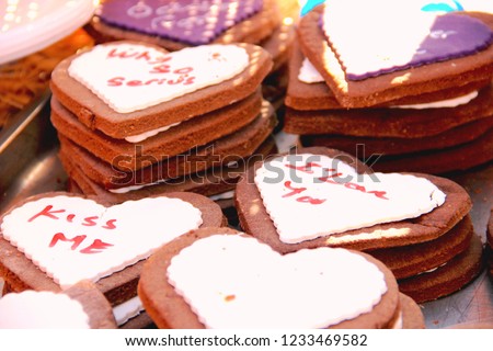 
Delicious heart-shaped chocolate chip cookies or gingerbread cookies coated with white and purple frosting with the English words 'Kiss Mi'. Valentine's day gift. Popular spicy hearts-sweets Zdjęcia stock © 