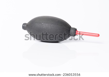 Air blower cleaning a camera with white background