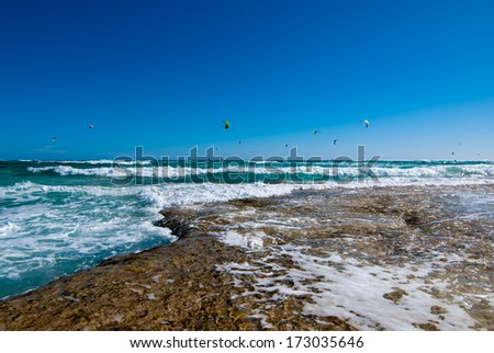 Kitesurfers and sunlit waves of Atlantic Ocean on Fuerteventura Island, Spain