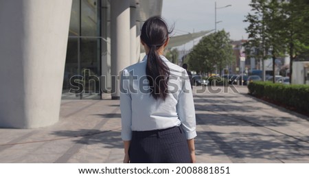 Similar – Image, Stock Photo Stylish businesswoman walking along street in city