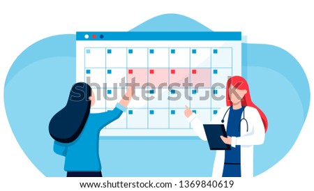 A young woman marks the date of menstruation in the online calendar. An application to track your menstrual cycle and birth control. Online doctor gynecology
