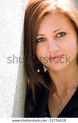 Young Brownhaired Caucasian Woman Near a Wall Portrait