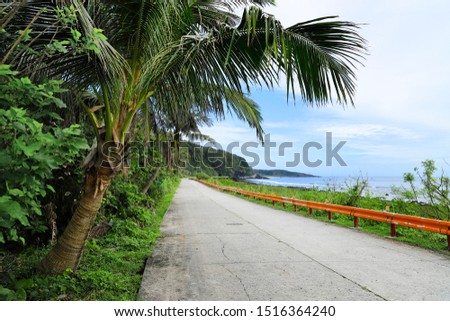 Along this peaceful country road with tropical trees around. It's a famous tour attraction in Taiwan called 'Green Island', located south east of Taiwan, about 50 minute boat trip. 商業照片 © 