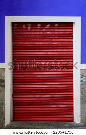 Rolling door or shutter door pattern red color, blue wall