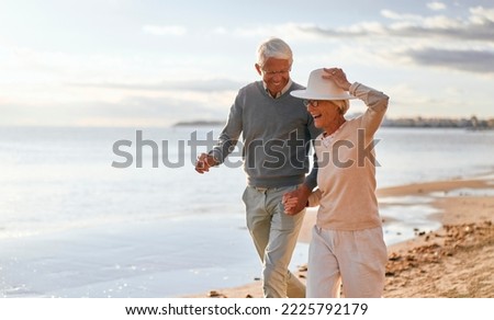 Similar – Image, Stock Photo Elderly couple walking a forest path along the seashore holding giant inflatable flamingo and unicorn. Funny active pensioners enjoying summer vacation on the beach in Northern Europe