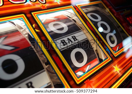 https://image.shutterstock.com/display_pic_with_logo/2078678/509377294/stock-photo-a-close-up-of-a-colourful-gambling-slot-machine-with-the-central-spinner-showing-bar-509377294.jpg
