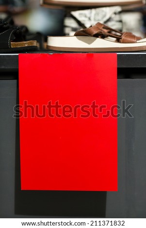 Red sign in front of store. Text has been removed. Please insert your own text.