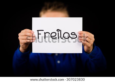 Studio shot of child holding a sign with German word Freilos - See You Later